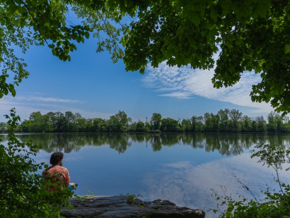 Man sitting on river bank
