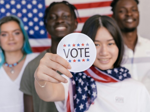 Woman holding vote sticker