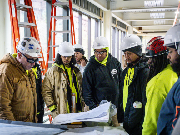 people looking at construction plans