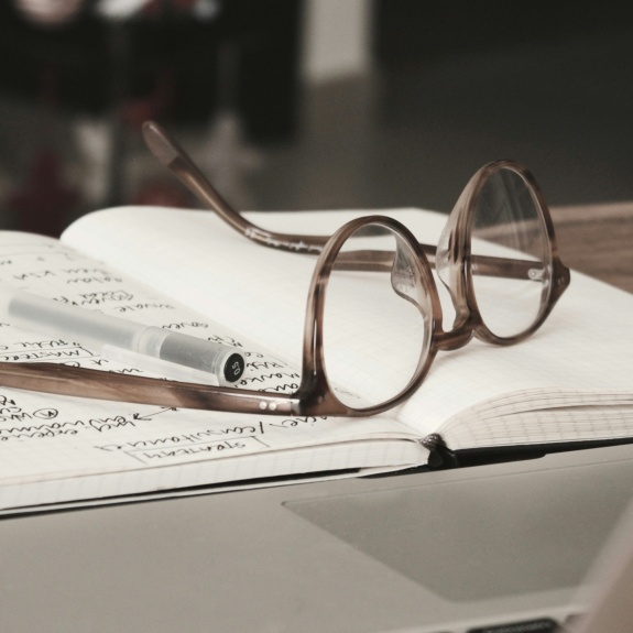 eyeglasses on top of notebook