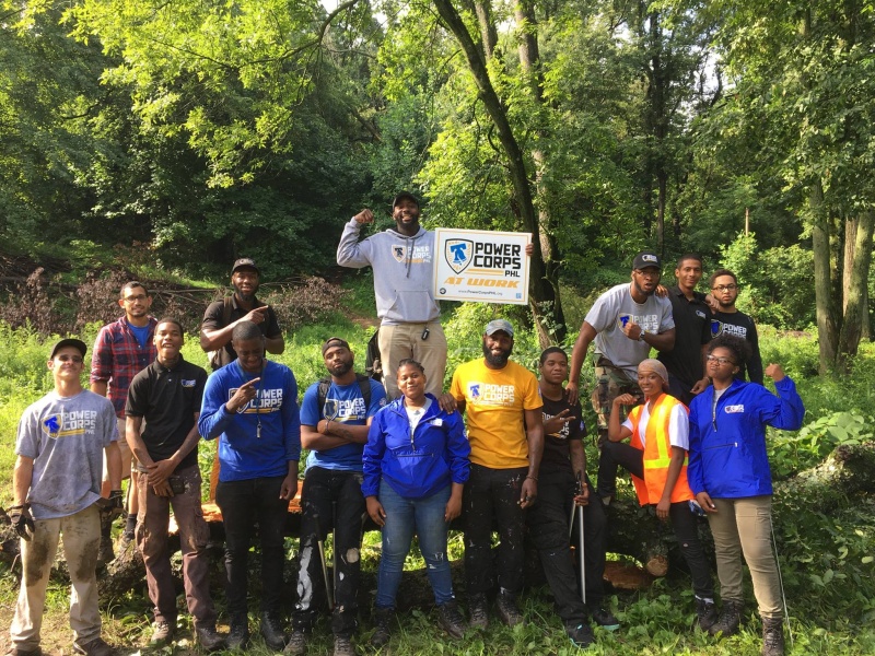 PowerCorpsPHL program participants posing surrounded by trees.
