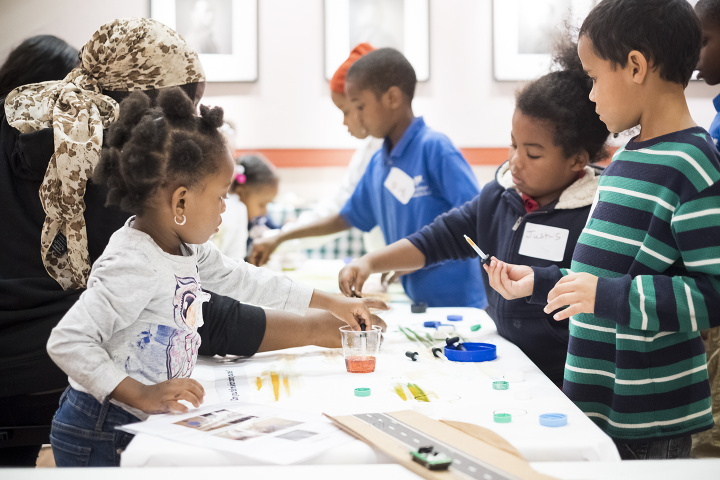 A group of children at a table doing an educational activity