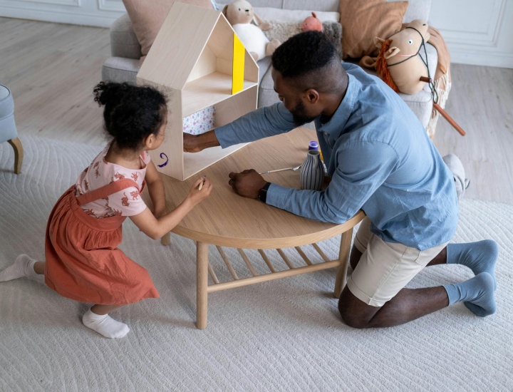 Adult and child with toy house