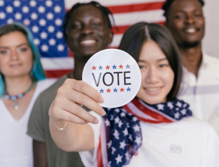 Woman holding vote sticker