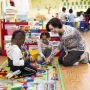 children and teacher in early childhood education center